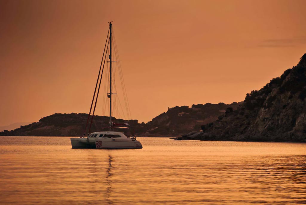 Crewed Sailing Yacht Catamaran at sunset