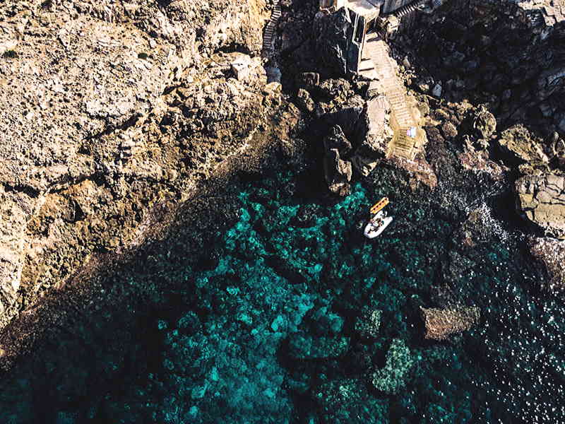 Aerial shot of rocky Mediterranean shore with crystal clear sea